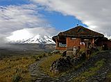 Ecuador Cotopaxi 01-08 Tambopaxi Outside I wanted to have lodging with a view at all times of Cotopaxi, as I quite rightly worried about it being in the clouds most of the time. For the two days we were there, Cotopaxi only showed itself at sunset. One of the staff at Tambopaxi mentioned that Cotopaxi was clear only one morning in the previous seven. I found the perfect choice for accommodation in Tambopaxi (3750m) which is situated in Cotopaxi National Park with a perfect view of the north face of Cotopaxi.